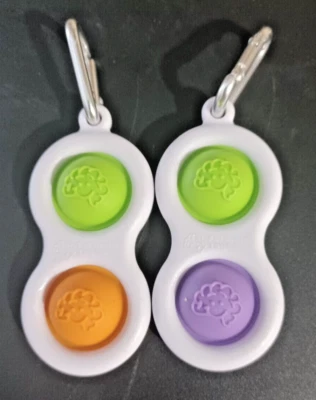 Pair Fat Brain Simple Dimpl Pop It Keychains in Orange Lime & Purple Lime - Image 1 of 2