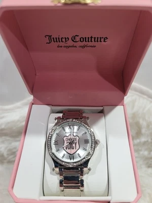 Reloj Juicy Couture cara plateada con bisel de pedrería rosa, correa color plata Foto 1 de 3