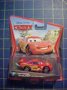 DISNEY PIXAR CARS 2 LIGHTNING McQUEEN WITH RACING WHEELS #3 NIP WORLD GRAND PRIX - Picture 1 of 3