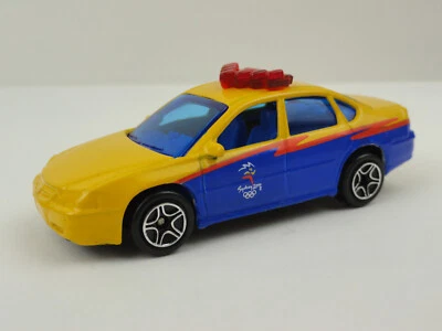 Coche de policía Chevrolet Impala 2000 Matchbox Juegos Olímpicos de Sydney (amarillo) - suelto Foto 1 de 4