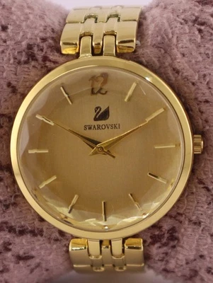 Hermoso reloj pulsera Swarovski para mujer esfera dorada caja GP cuarzo funcionando correa de acero Foto 1 de 4