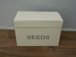cream metal lidded seed tin