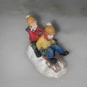Weihnachtsdorf Figur Kinder Schlittenfahren. - Bild 1 von 4