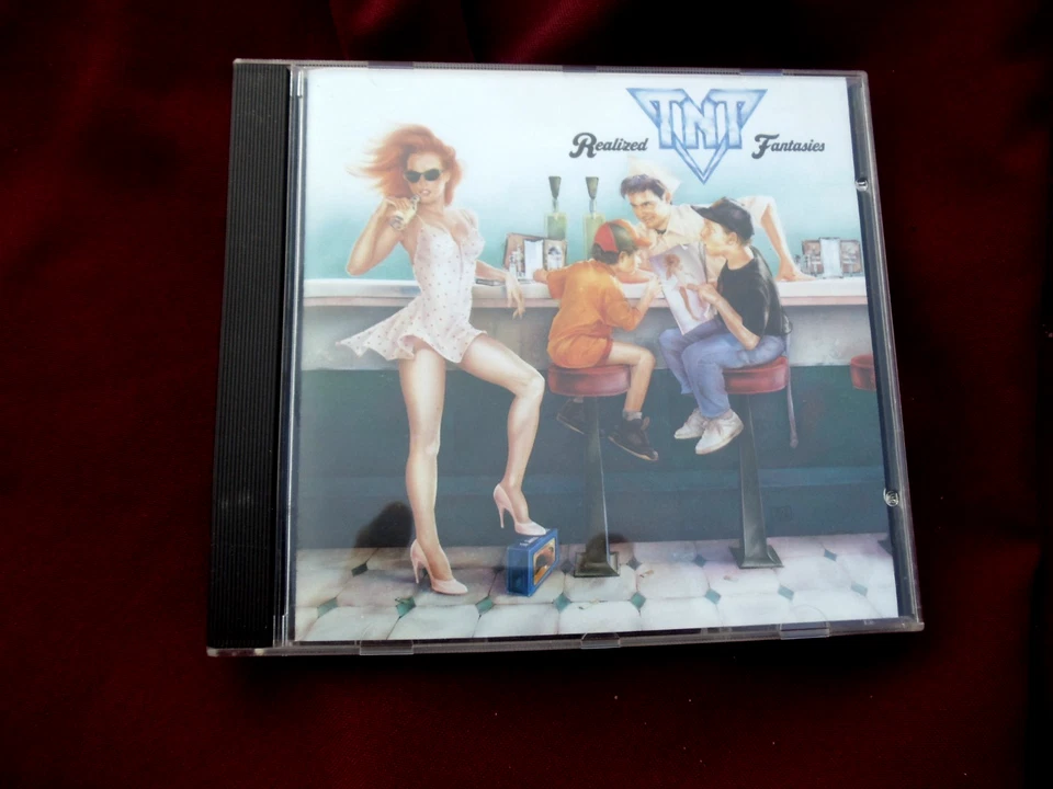  TNT  - Realized Fantasies - Booklet/hülle neu. cd ein paar kleine kratzer. - Bild 1 von 1