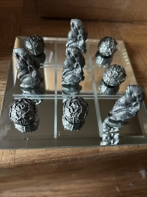 Pewter Lop Eared Rabbit And Cabbages Tic Tac Toe Set On Mirrored Glass Board. - Image 1 of 4