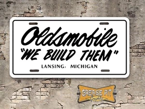 Oldsmobile "We Build Them"  Novelty Aluminum License Plate White Black - Picture 1 of 1