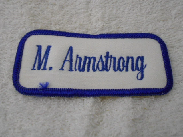 M. ARMSTRONG  USED EMBROIDERED  SEW ON NAME PATCH TAGS BLUE ON WHITE - Image 1 of 1