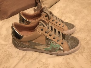 black and gold guess trainers