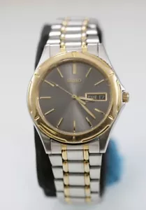Montre Seiko homme argent or acier inoxydable WR pile gris jour date quartz - Photo 1 sur 6
