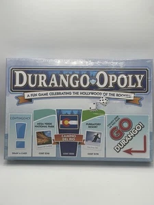 Drango Opoly Gioco da Tavolo Celebra Il Fattore Hollywood Delle Montagne Rocciose Sigillato �� - Foto 1 di 8
