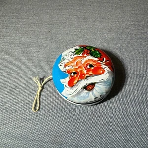 Juguete YoYo de hojalata de metal vintage con cara de Santa - Imagen 1 de 4