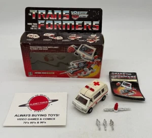 Figura de coche Ratchet 1984 con cruz completa con caja G1 Transformers - Imagen 1 de 4