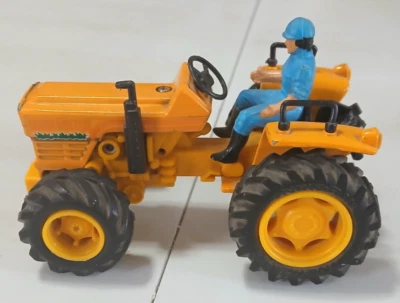 New Ray Farm Motor Tractor  Friction Powered  Toy. Orange. 4" Long. - Image 1 of 4