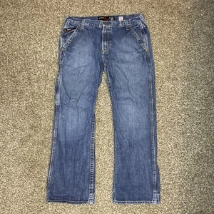 Ariat FR Jeans Mens M4 Relaxed Boot CAT2 Flame Resistant Blue 34x30 Distressed - Picture 1 of 10