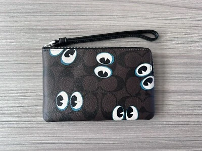 NUEVO CON ETIQUETAS Muñequera Coach Esquina Cremallera Firma Lona Halloween Ojos Espeluznantes Negra CN005 Foto 1 de 4