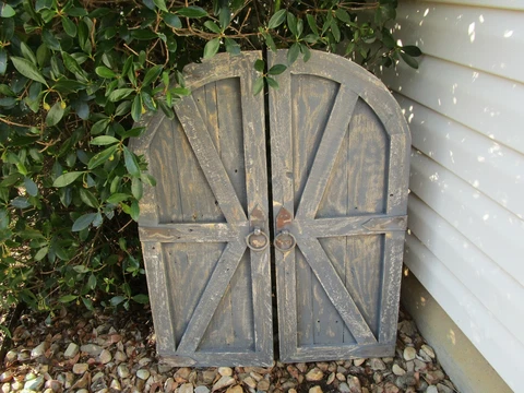 Pair of distressed gray vintage inspired round top barn doors with hardware Cover