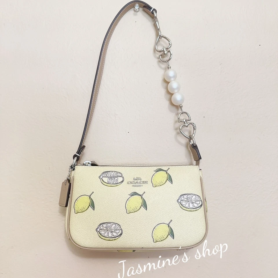 Coach Women's Cal27 Nolita 19 In Coated Canvas With Orange Print Wristlet