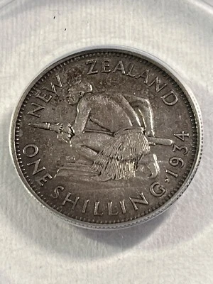 Moneda de plata de 1 chelín de Nueva Zelanda 1934 graduada AU 50 por ANACS Foto 1 de 4
