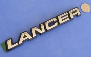 DODGE LANCER REAR EMBLEM SCRIPT MOPAR OEM NEW BADGE 84-89 85 86 87 88 SILVER/BK - Bild 1 von 4