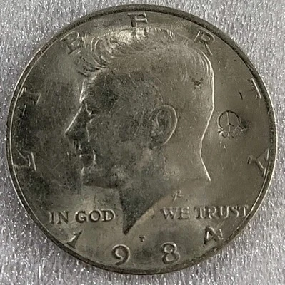 1984-P Kennedy Half Dollar, Circulated with Peace Symbol Stamp *C427 - Image 1 of 4