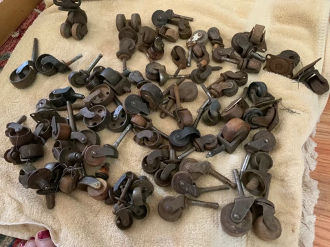 Salvaged odd lot of old wood/metal casters Cover