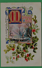 Christmas embossed postcard/holly/ bridge/snow clouds/ large gold "M"/