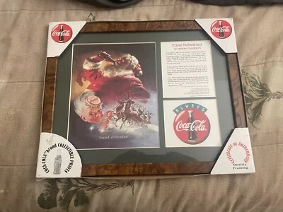 1998 Coca Cola Haddon Sundblom Travel Refreshed Santa & Sprite Boy Framed Print - Image 1 of 4