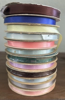 12 SPOOLS OF SATIN RIBBON.  “SINGLE FACE SATIN WITH WOVEN EDGE” - Image 1 of 2