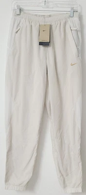 Calça de futebol Nike Therma-FIT Culture of Football creme FN2391-104 masculina tamanho M - Imagem 1 de 3