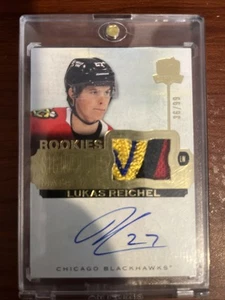 Parche automático LUKAS REICHEL 2022-23 The Cup Rookies Signature Materials SP-LR 36/99 - Imagen 1 de 2