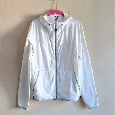 Chaqueta cortavientos ZERØGRAND Cole Haan blanca embalable para correr talla L para mujer Foto 1 de 4