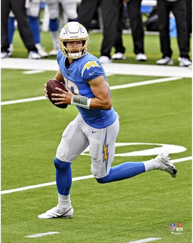 Justin Herbert Los Angeles Chargers Unsigned Powder Blue Jersey Scrambling Photo Cover
