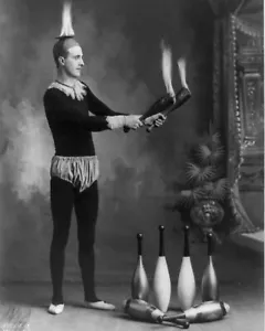 J.T. Doyle holding 2 burning juggling clubs Circus Carnival fire show 8X10 Photo - Picture 1 of 1