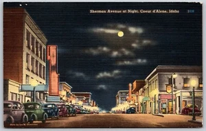 Postcard Idaho Coeur d'Alene Sherman Avenue at Night Full Moon Old Cars - Picture 1 of 2
