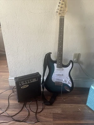 Blue Black And White Electric Guitar With 6 Strings A Strap And￼a Amplifier￼ - Image 1 of 4