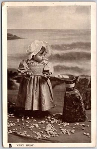 Very Busy Cute Little Girl Busy Playing Stones In The Ocean Postcard - Picture 1 of 2