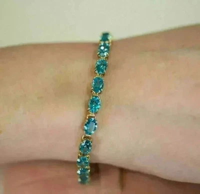 Pulseira de tênis folheada a ouro amarelo 14k corte oval 13 quilates topázio azul criado em laboratório 7,5" - Imagem 1 de 4