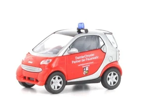 Busch 489312 Smart City Coupe Pompiere Saarland HO 1:87 NUOVO - Foto 1 di 1