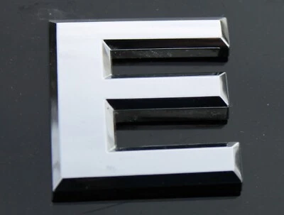 OEM NISSAN 2005-2016 Frontier Chrome Letter "E" Emblem - Image 1 of 4
