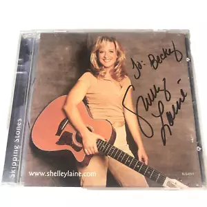 SHELLEY WOLL - SKIPPING STONES - AUTOGRAMMIERT - AUDIO CD - Bild 1 von 2
