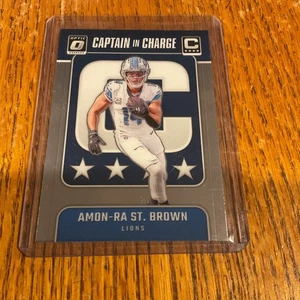 2024 Panini Donruss Optic Amon-Ra St. Brown Lions #5 Capitán a cargo - Imagen 1 de 3