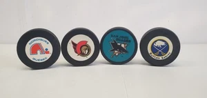 Vintage Hockey Pucks Lot Of 4 Nordique Sabres Senators Sharks NHL In Glas Co - Picture 1 of 6
