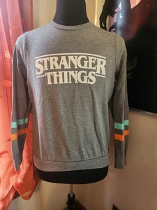Felpa Netflix Stranger Things grigia arancione acqua stampa righe manica taglia M - Foto 1 di 2