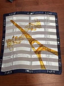 BUFANDA AZUL Y BLANCO 100% POLIÉSTER 40" CON TORRE EIFFEL Y GRÁFICO MUSICAL DE COLECCIÓN - Imagen 1 de 4