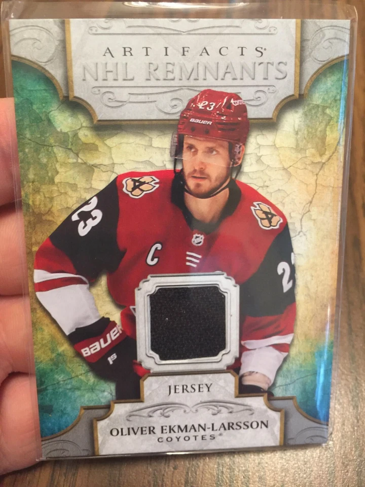 OLIVER EKMAN-LARSSON 2020-21 UD ARTIFACTS NHL REMNANTS COYOTES WORN JERSEY PATCH - Image 1 of 2