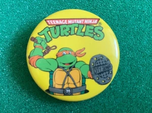 BOTÓN DE SOLAPA CON LICENCIA DE TORTUGAS NINJA MUTANTES ADOLESCENTES-MIGUEL ÁNGEL - Imagen 1 de 1