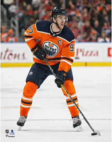Connor McDavid Edmonton Oilers Unsigned Orange Jersey Skating Photograph Cover