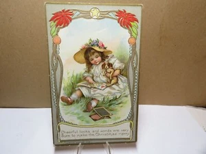 Fröhliches Weihnachtskind mit Welpe und Buch Postkarte 1910 - Bild 1 von 2