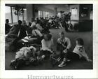 1986 Press Photo Passengers wait on floor at Houston Intercontinental Airport