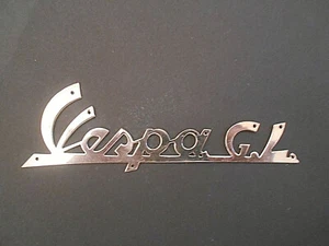 TARGHETTA SCRITTA FREGIO PIAGGIO VESPA 150 G.L. ACCIAIO LUCIDO - Foto 1 di 2